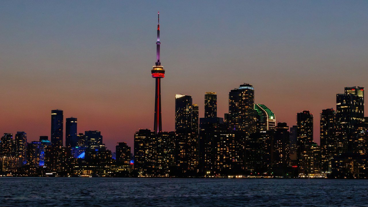 The Toronto tower at blue hour, seen from the harbour